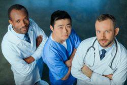 Three doctors looking up