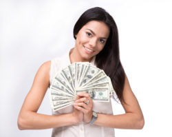 Woman smiling holding money