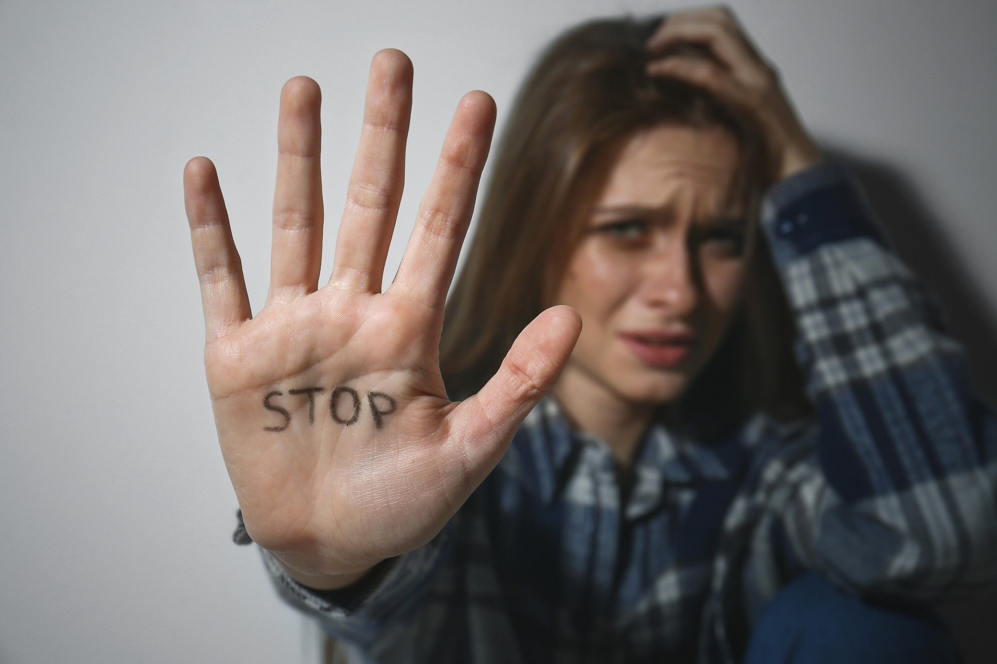 abused-teenage-girl-with-stop-on-hand