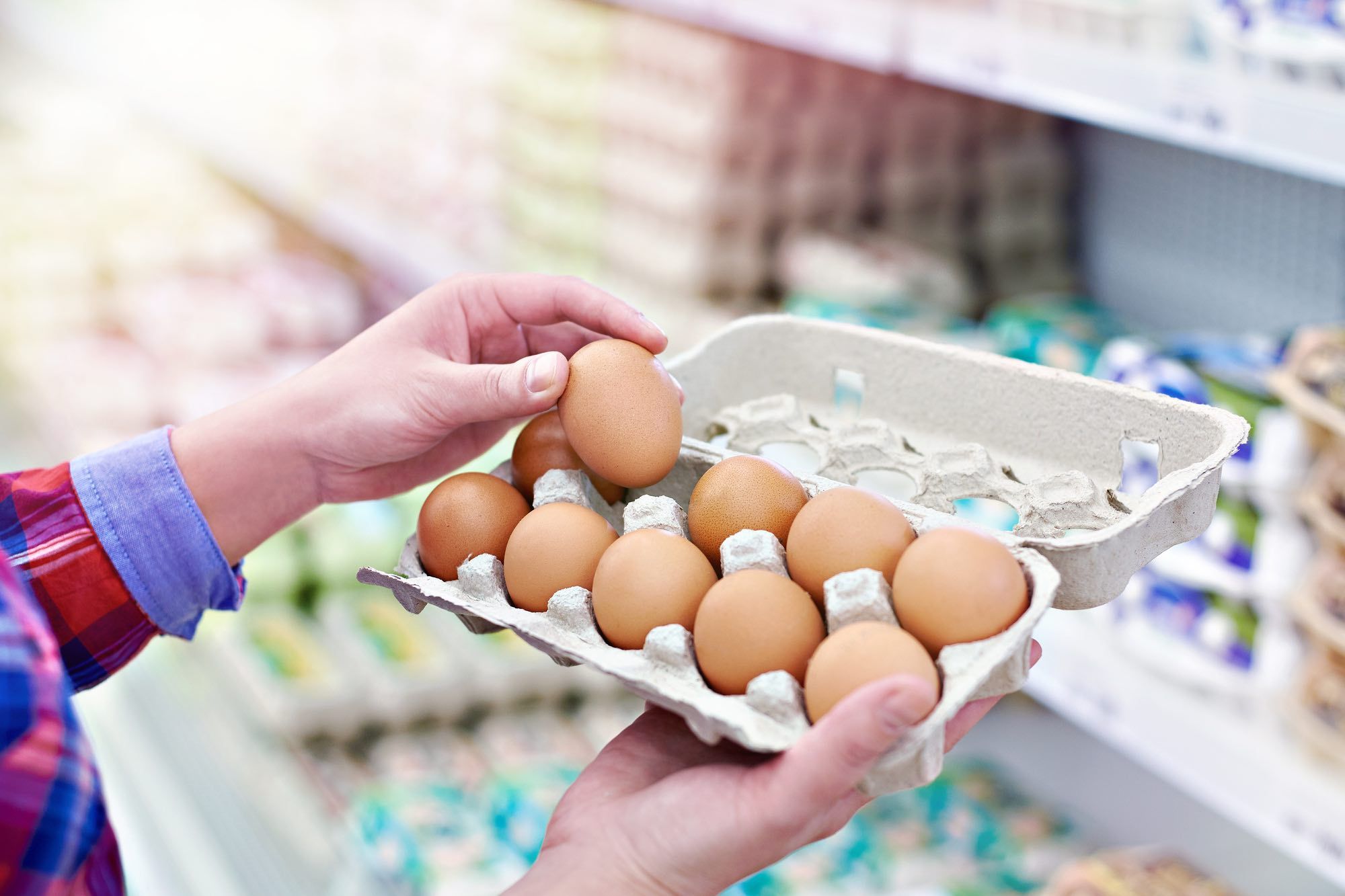 holding eggs looking at prices