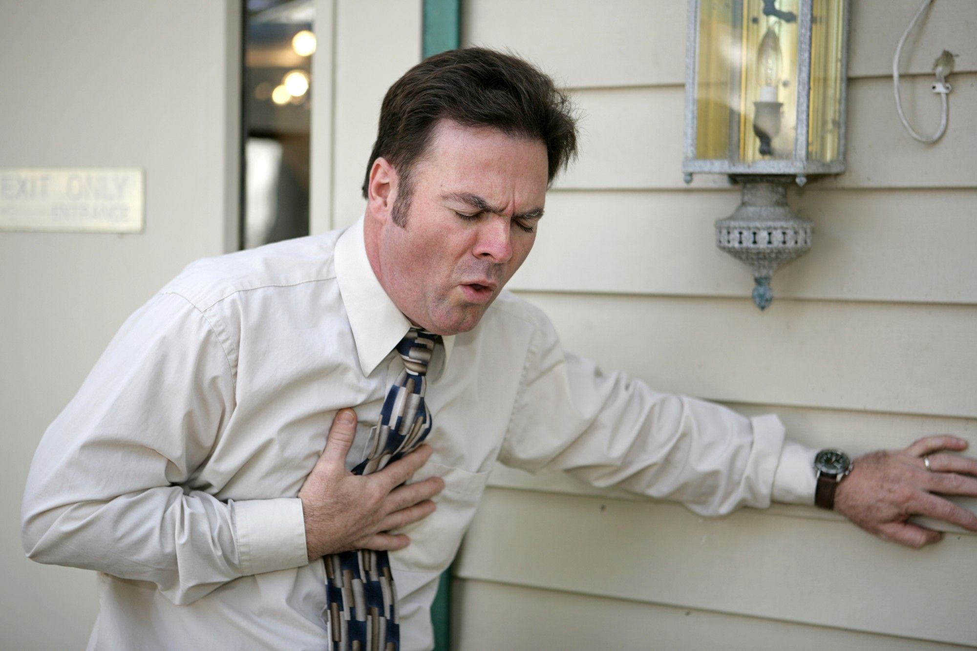 man holding chest and coughing