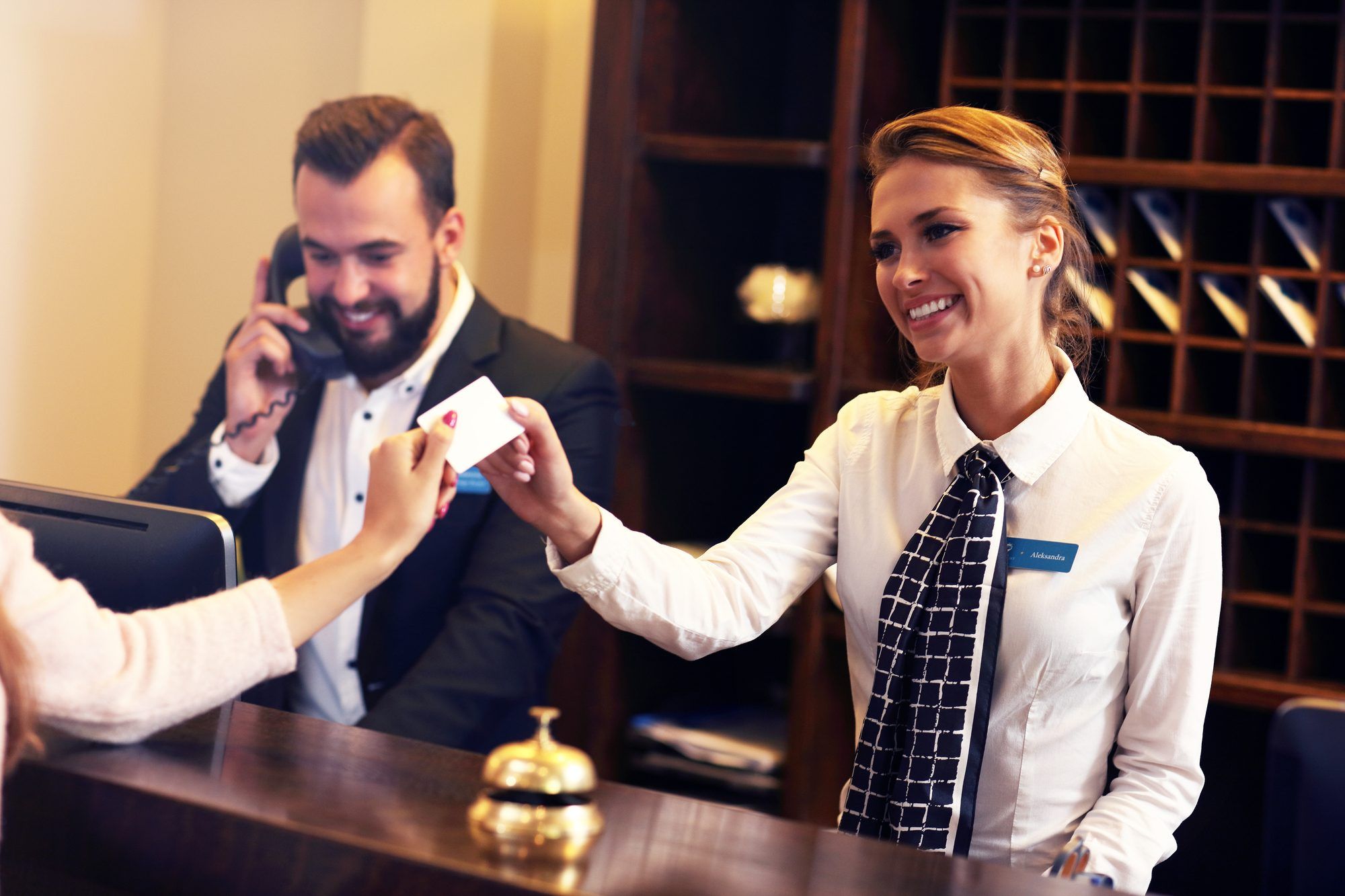 hotel front desk employee accepting credit card