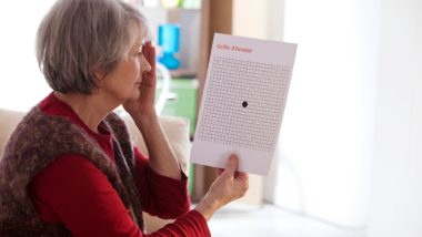 older woman taking macular degeneration eye screen