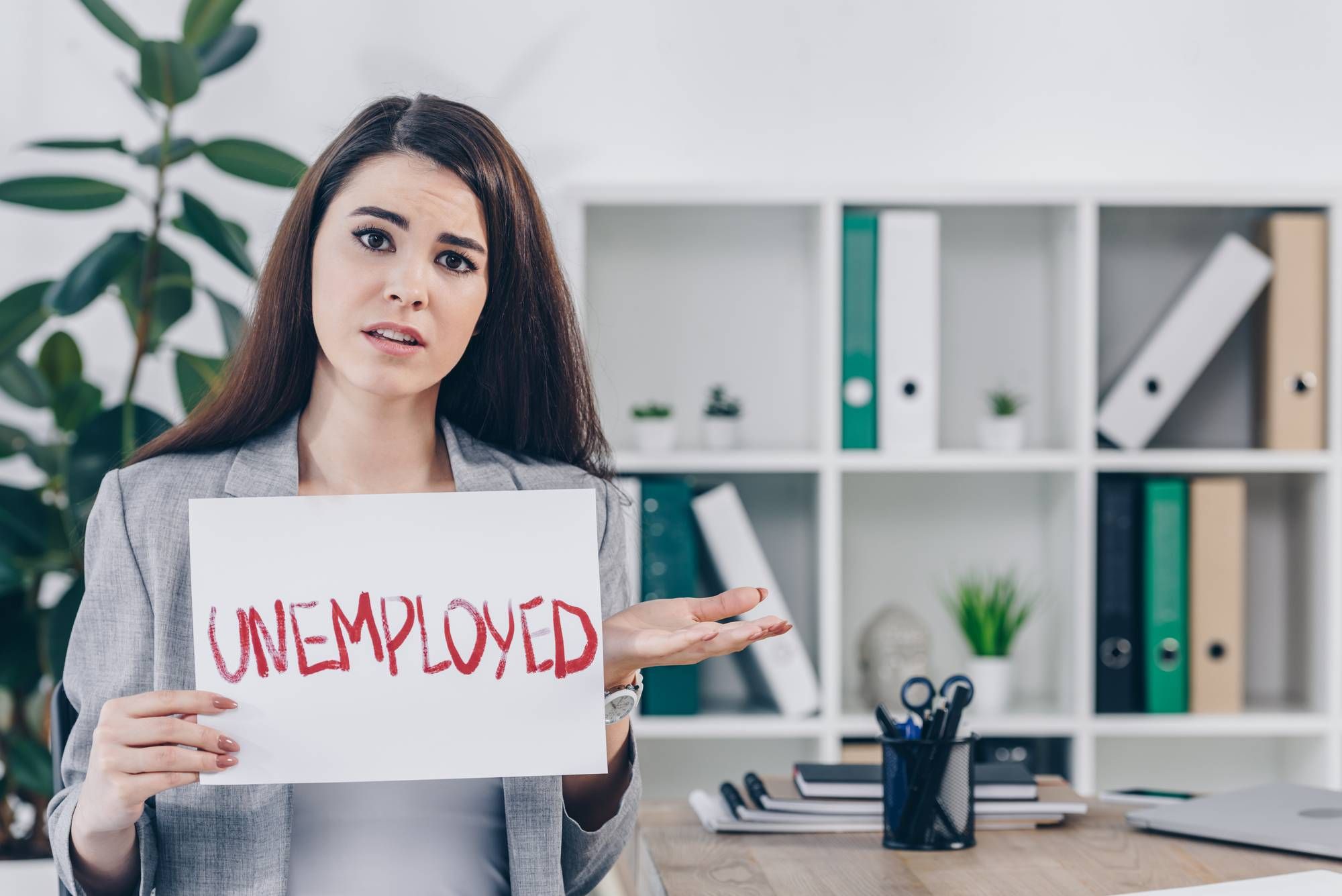 Woman holding Florida unemployment sign
