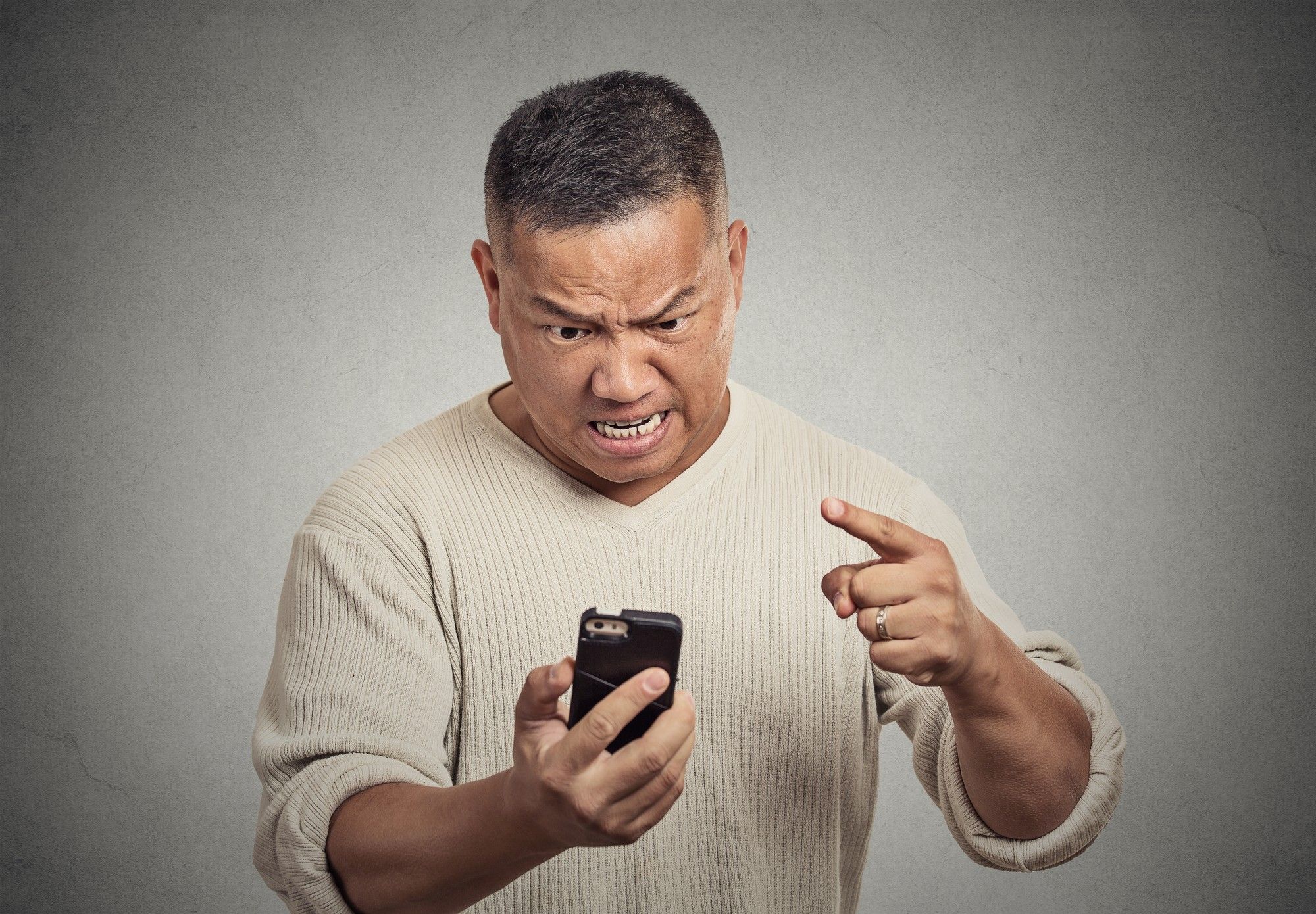 angry middle aged man Receiving Text Message Ads