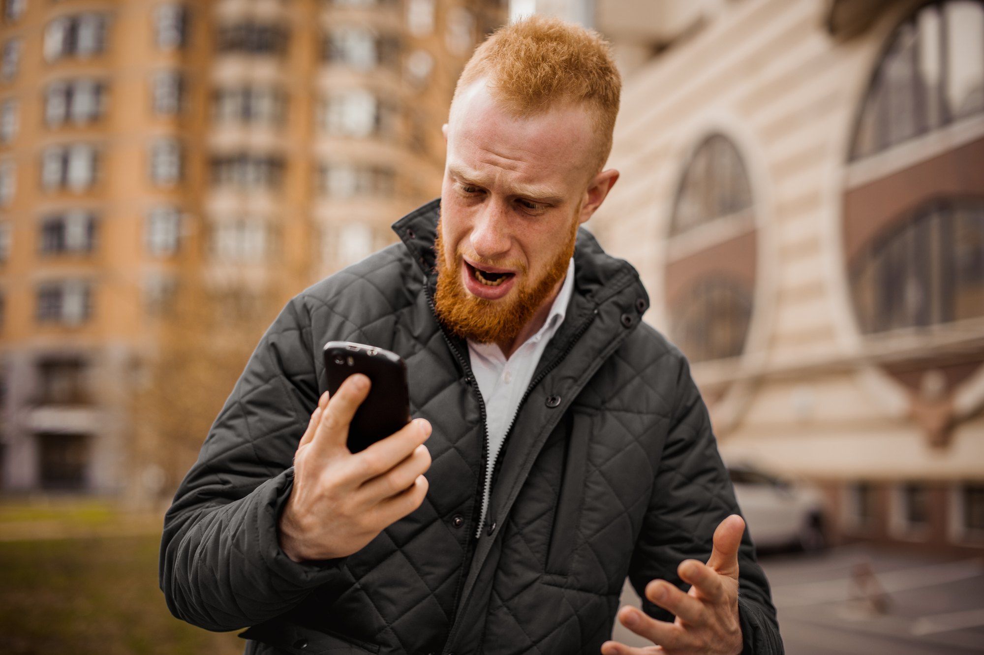 annoyed man yelling at cell phone