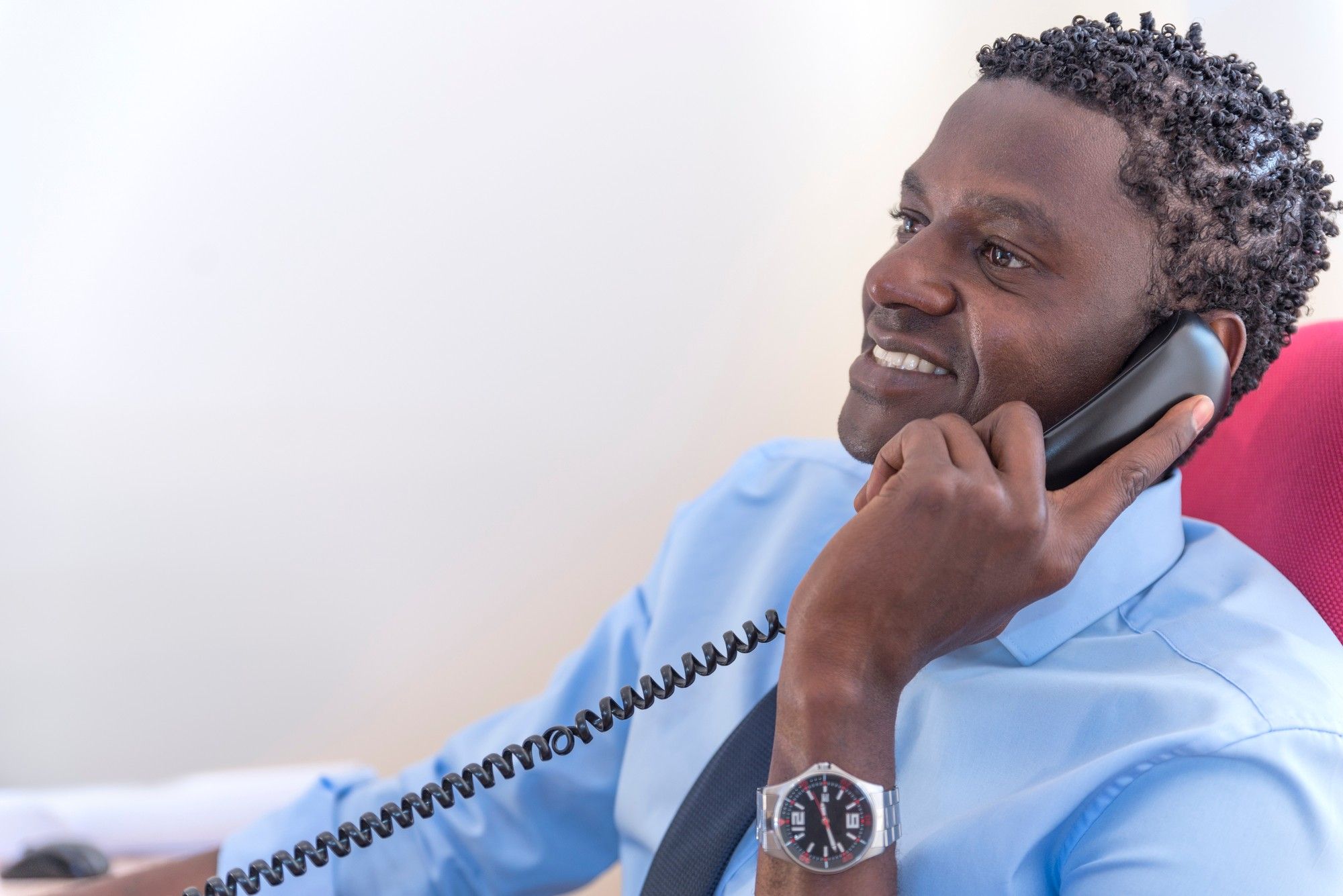 Young businessman on phone in office
