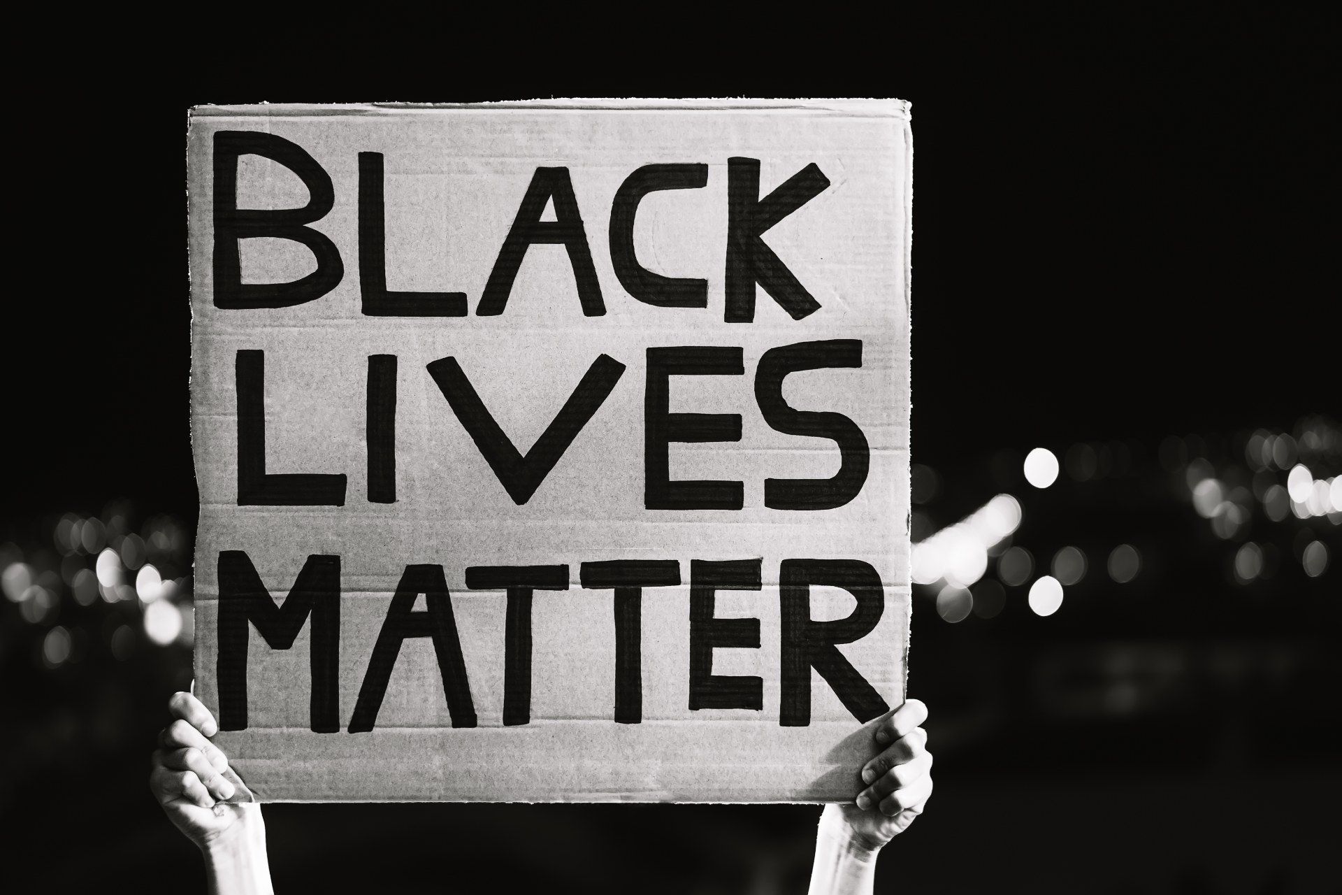 Person holds up a handmade Black Lives Matter sign during a protest