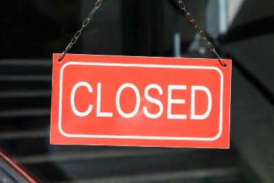 Red-and-white closed sign in window