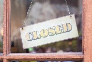 "Closed" sign hanging in window