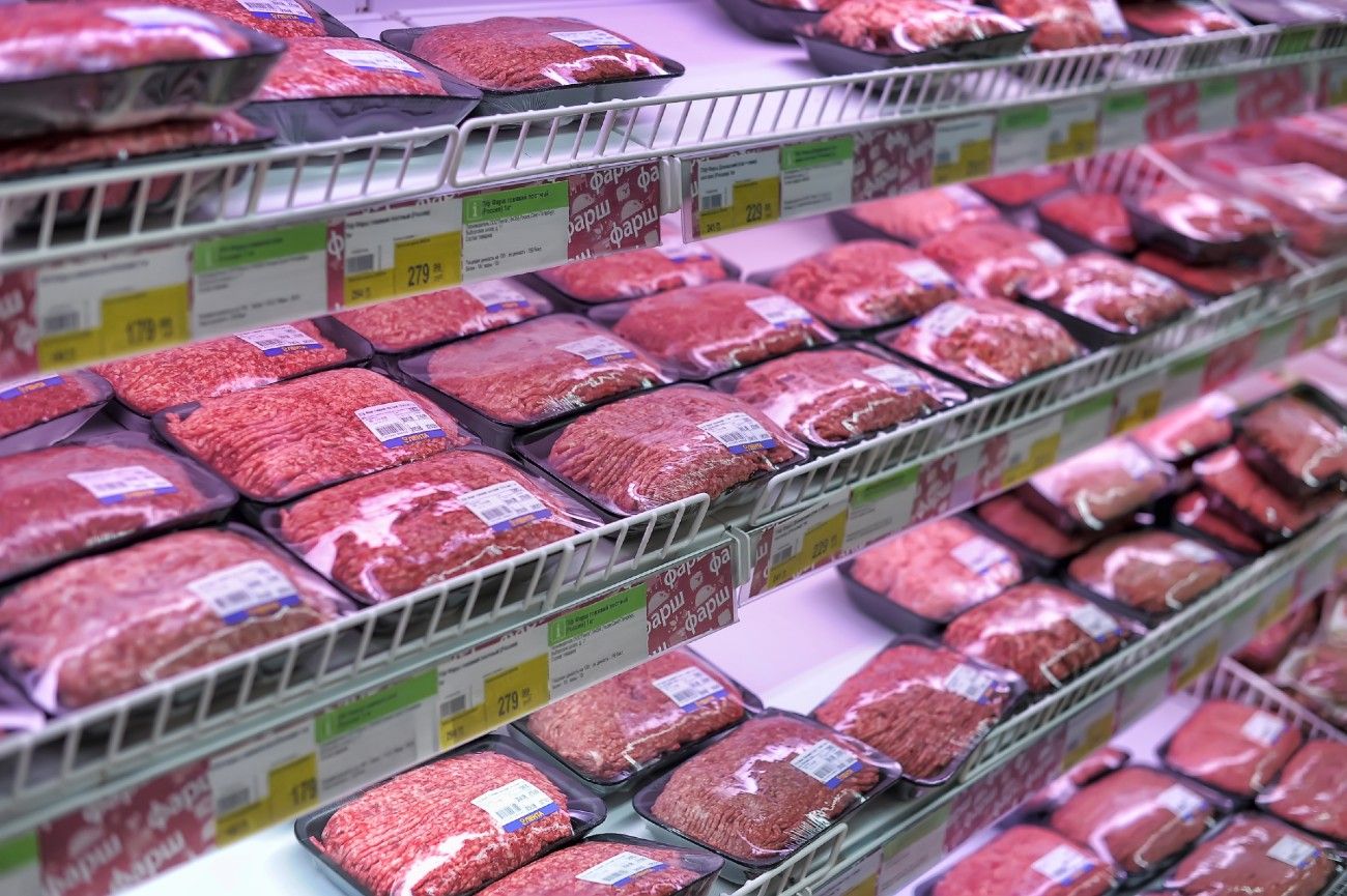 Packages of meat on grocery store shelves