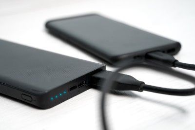 Smartphone plugged into portable power bank