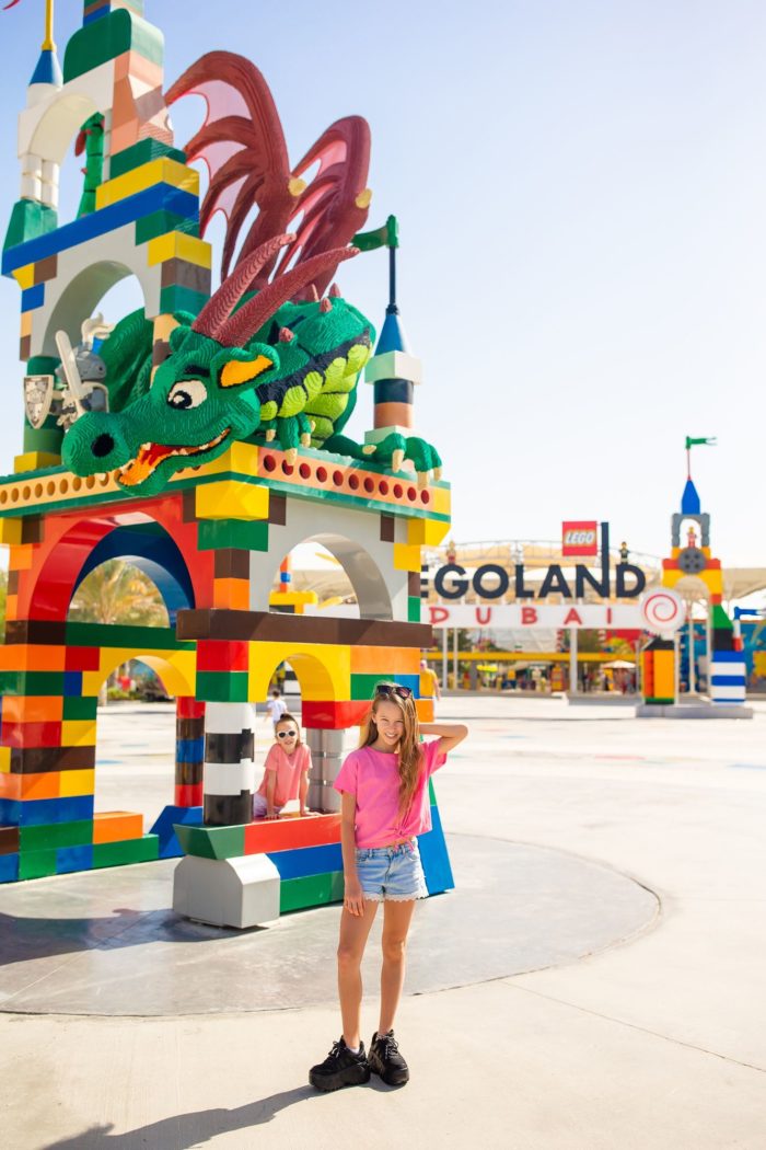 kids at legoland in front of dragon