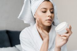 Woman using Blum Naturals skin care product