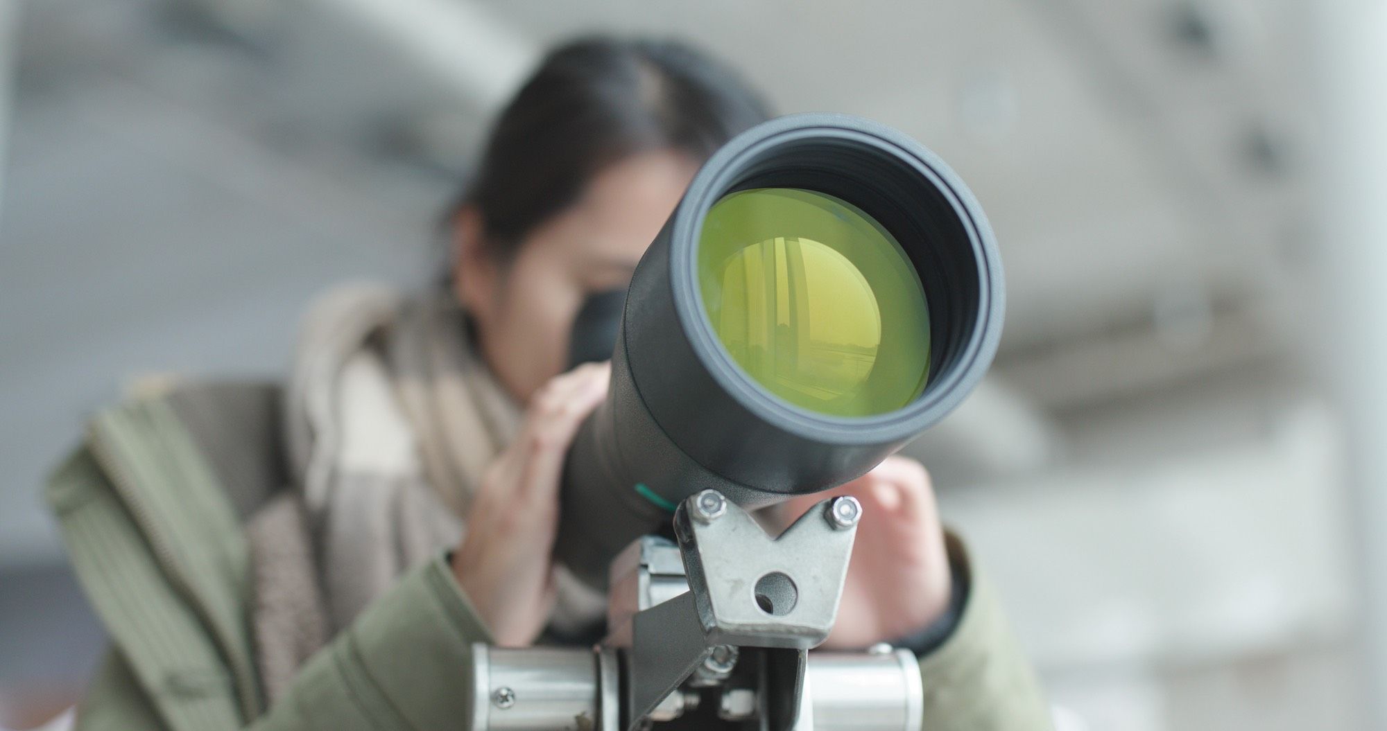 woman looking through telescope with expensive price
