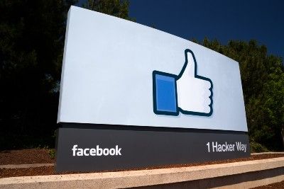 Sign with thumbs up logo outside Facebook corporate office