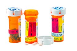 Close up of three orange prescription pill bottles
