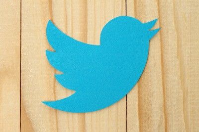 Twitter logo on wood background