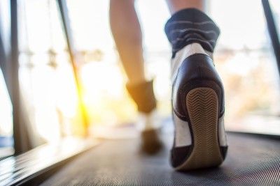 Closeup of feet walking on treadmill