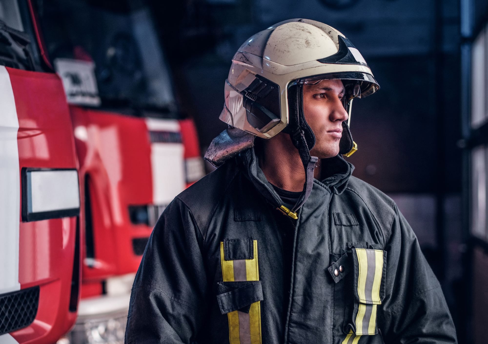 firefighter in front of fire engines