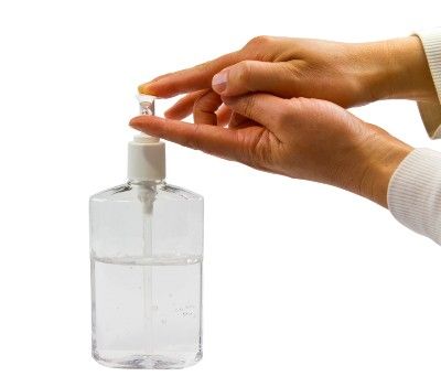 Person dispenses clear hand sanitizer onto their index finger