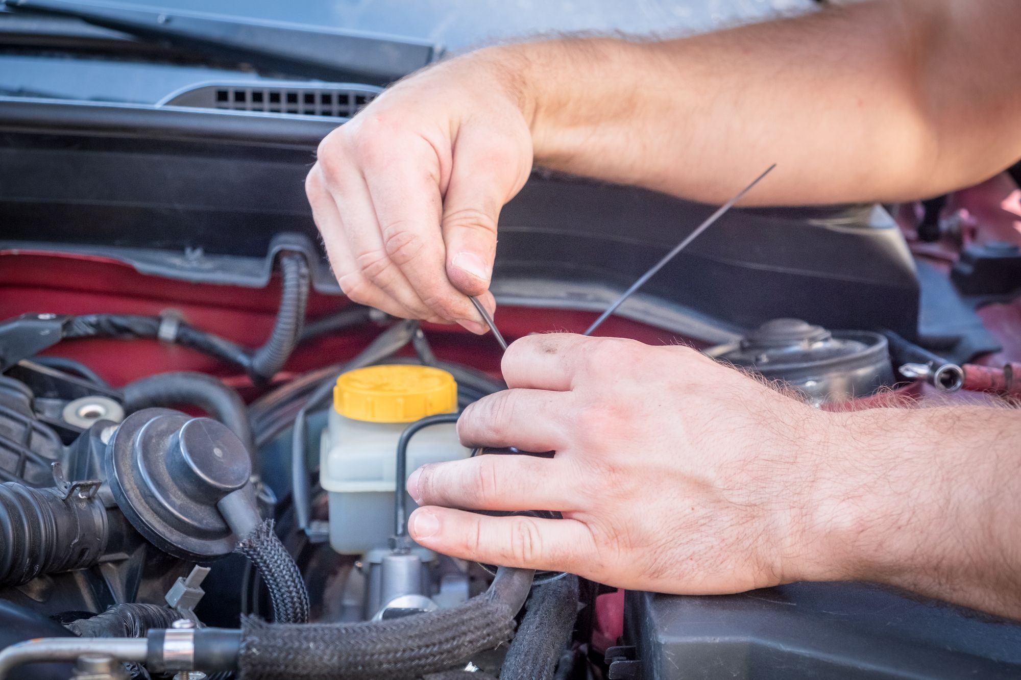 mechanic hands working on car engine