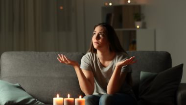 woman waiting out a blackout in living room