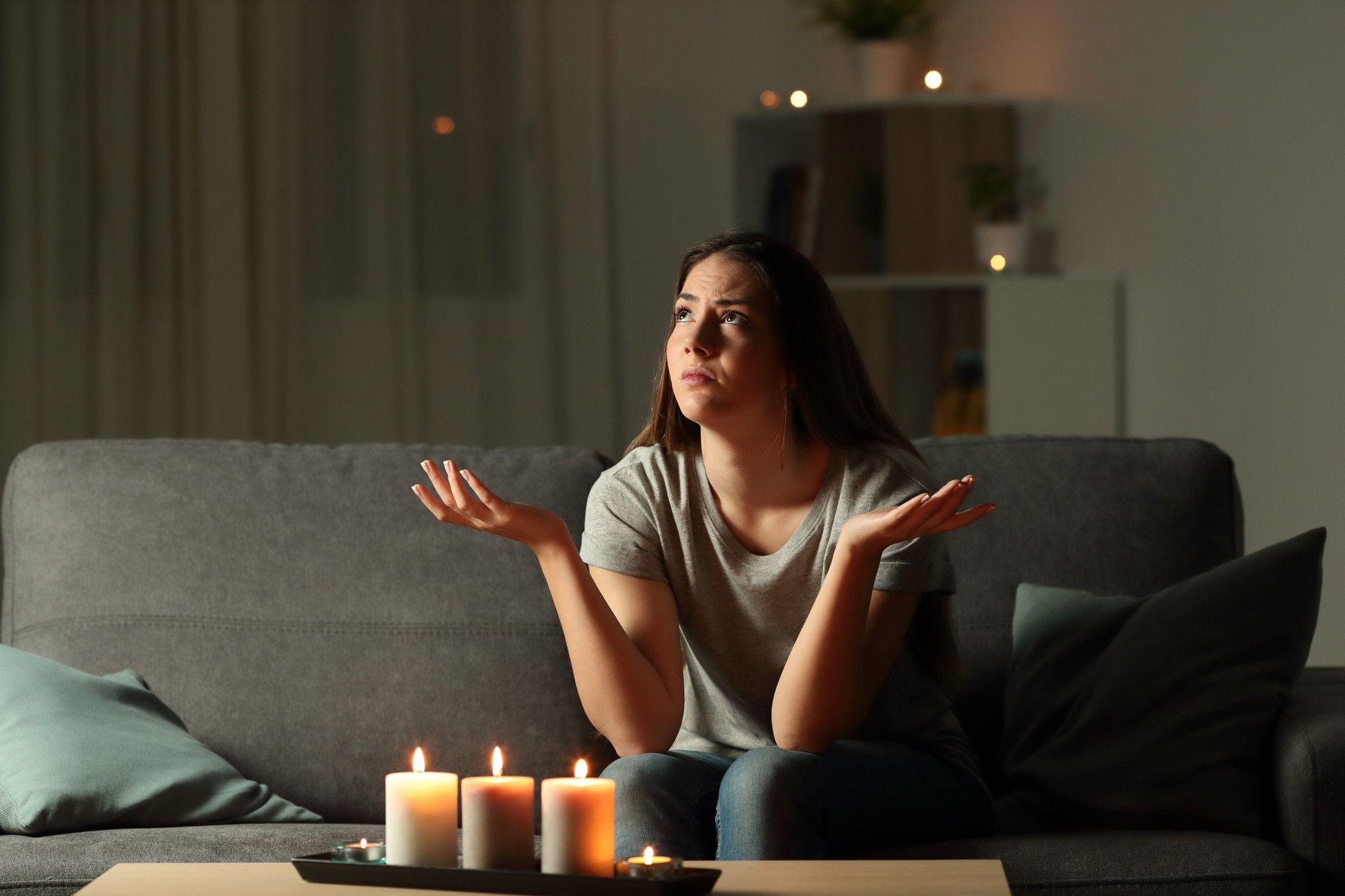 woman waiting out a blackout in living room