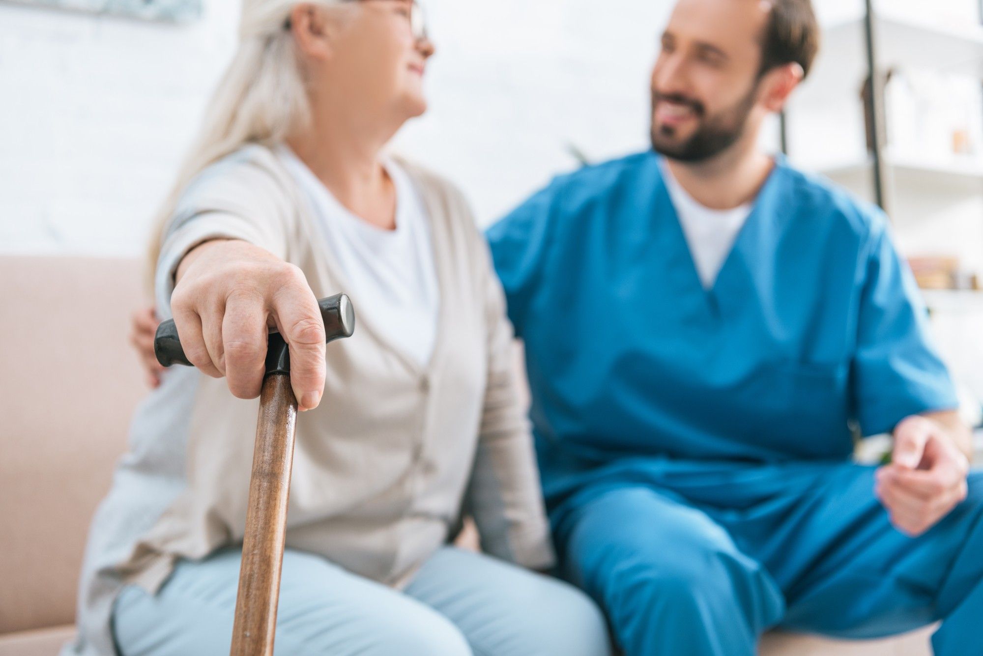 woman with walking cane looking at doctor
