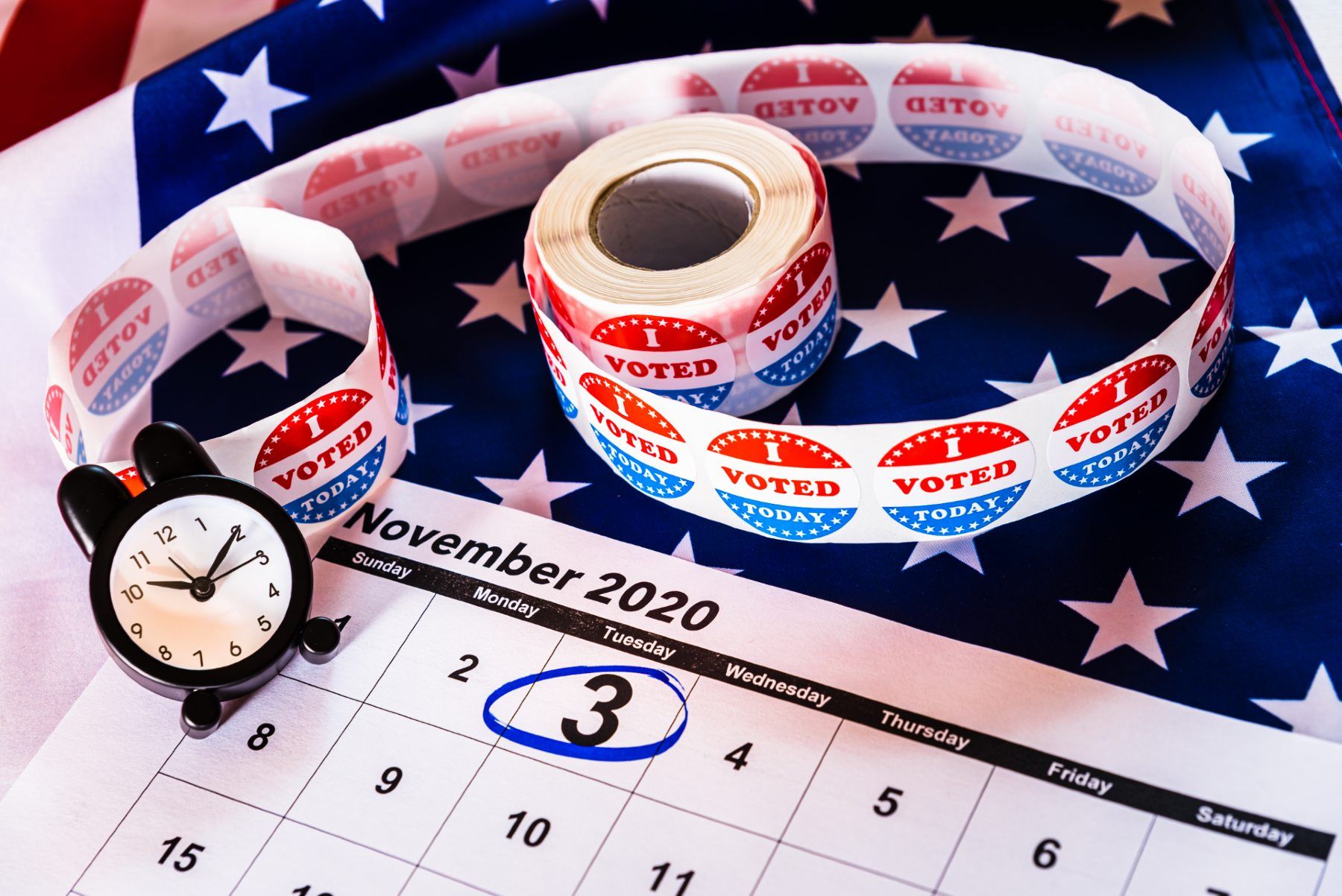 "I voted today" stickers lie on top of a calendar with Nov. 3, 2020, circled in blue - mail-in ballots