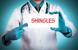 Doctor holds shingles sign