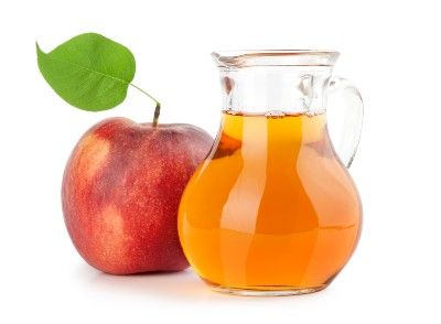 Apple sits next to pitcher full of apple juice - Mott's 100% Apple Juice