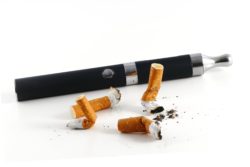 Vape pen beside cigarette butts