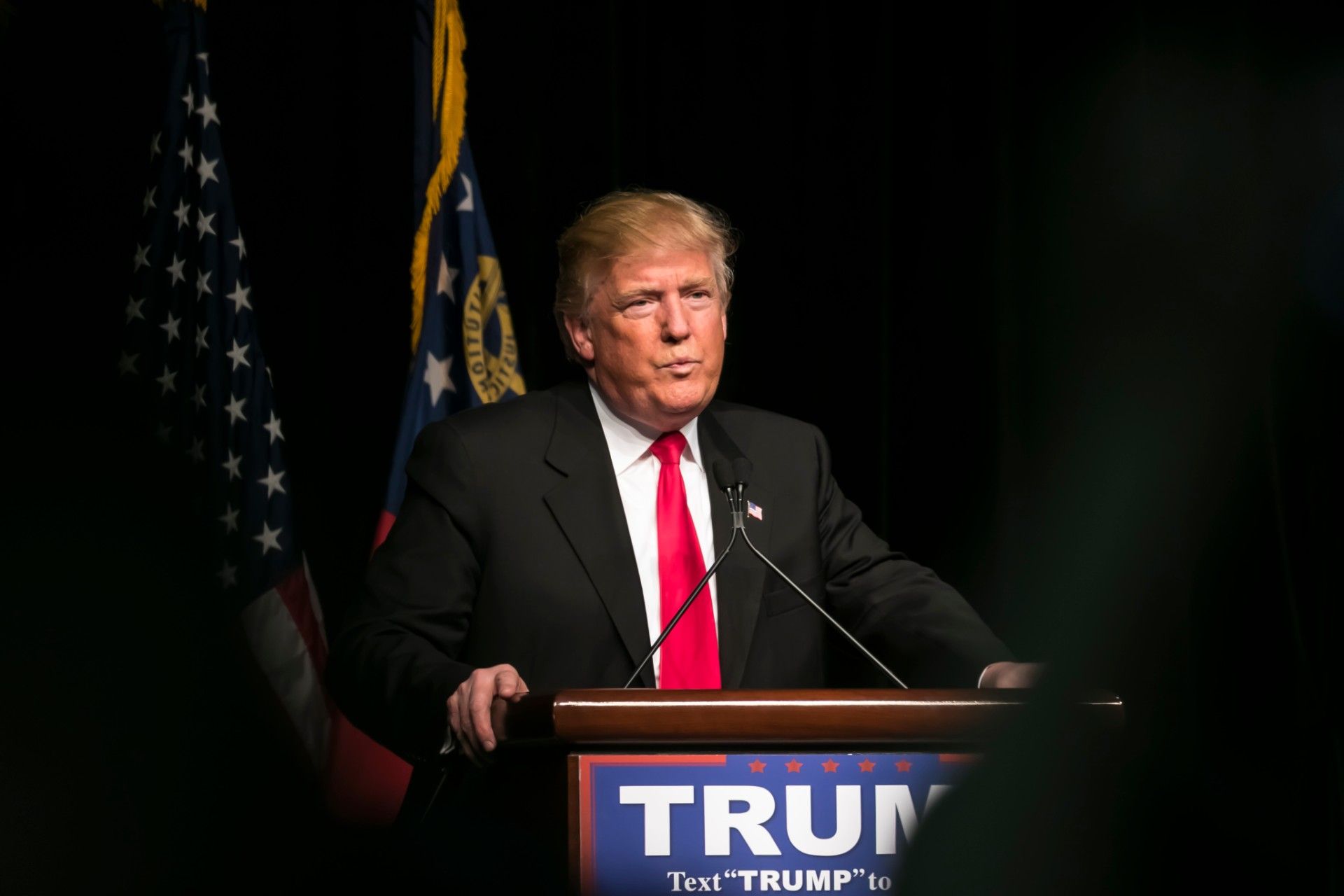 Donald Trump at podium during 2016 campaign - voting by mail