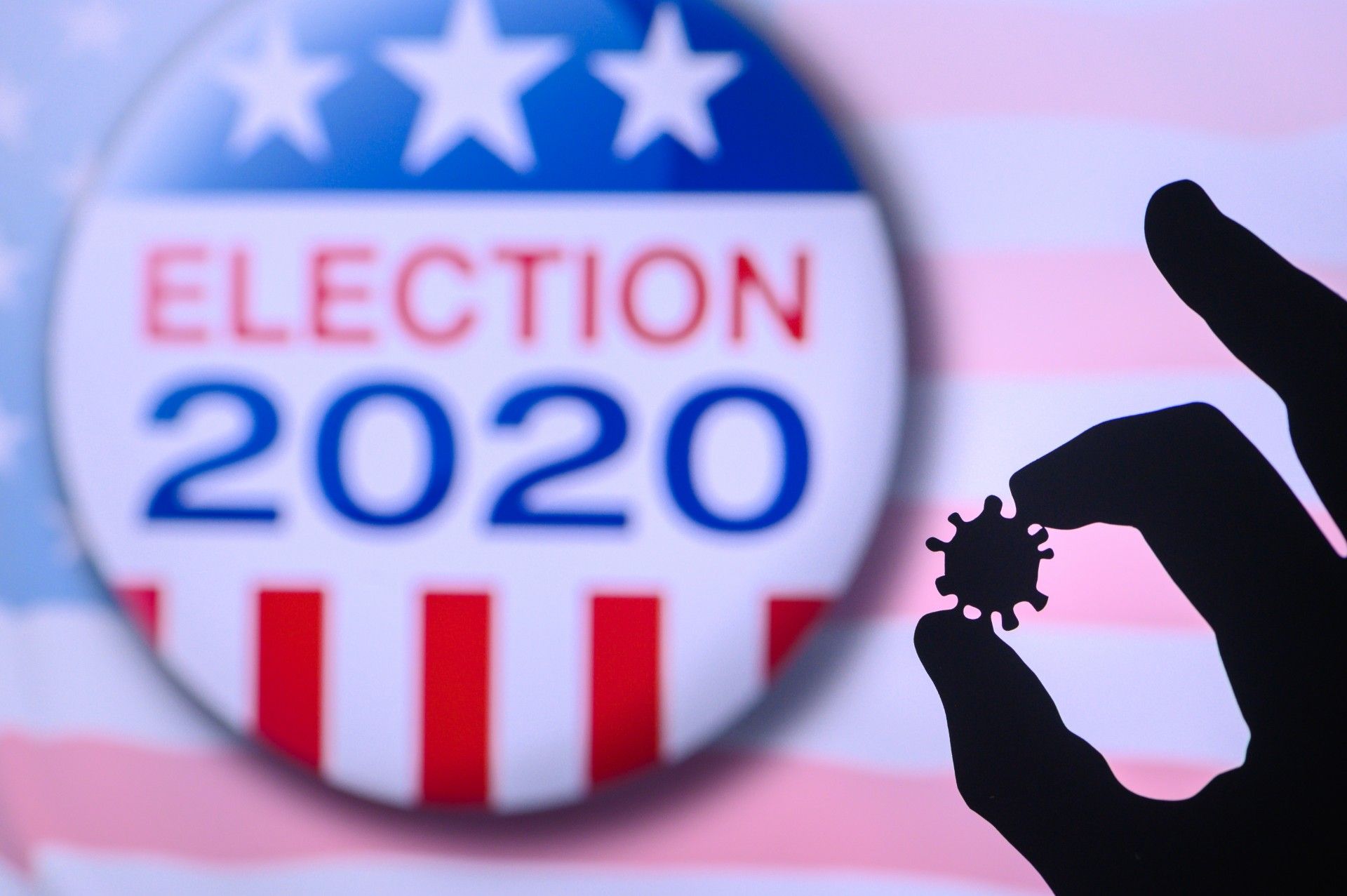 Silhouette of hand holding a coronavirus model between the thumb and forefinger, with red-white-and-blue "election 2020" graphic in the background- Nevada voters