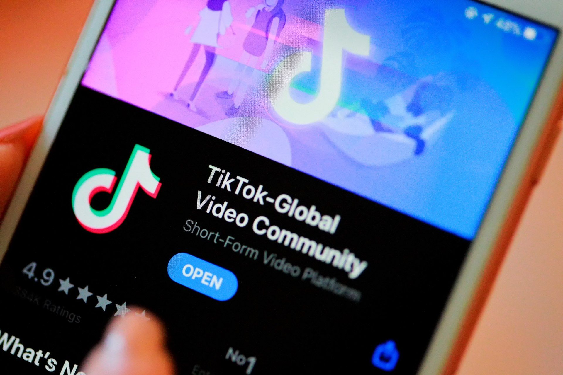 A person downloads visits TikTok on a smartphone app store - TikTok app