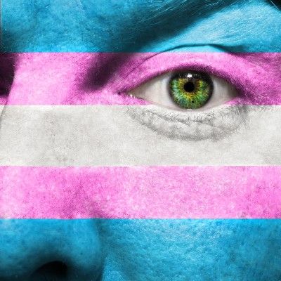 Transgender flag colors overlay a face