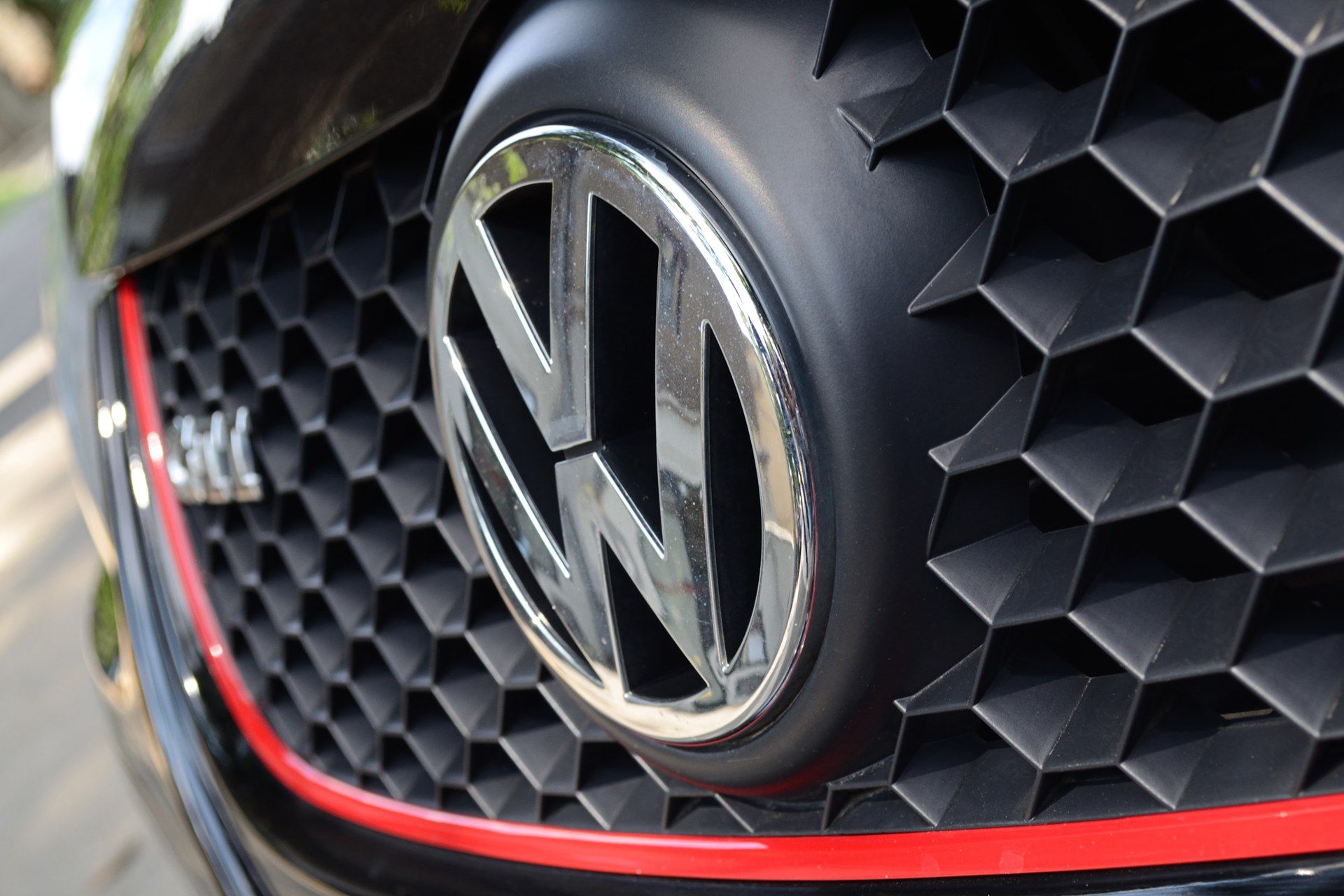 Volkswagen logo on black-and-red car grille - Volkswagen dieselgate