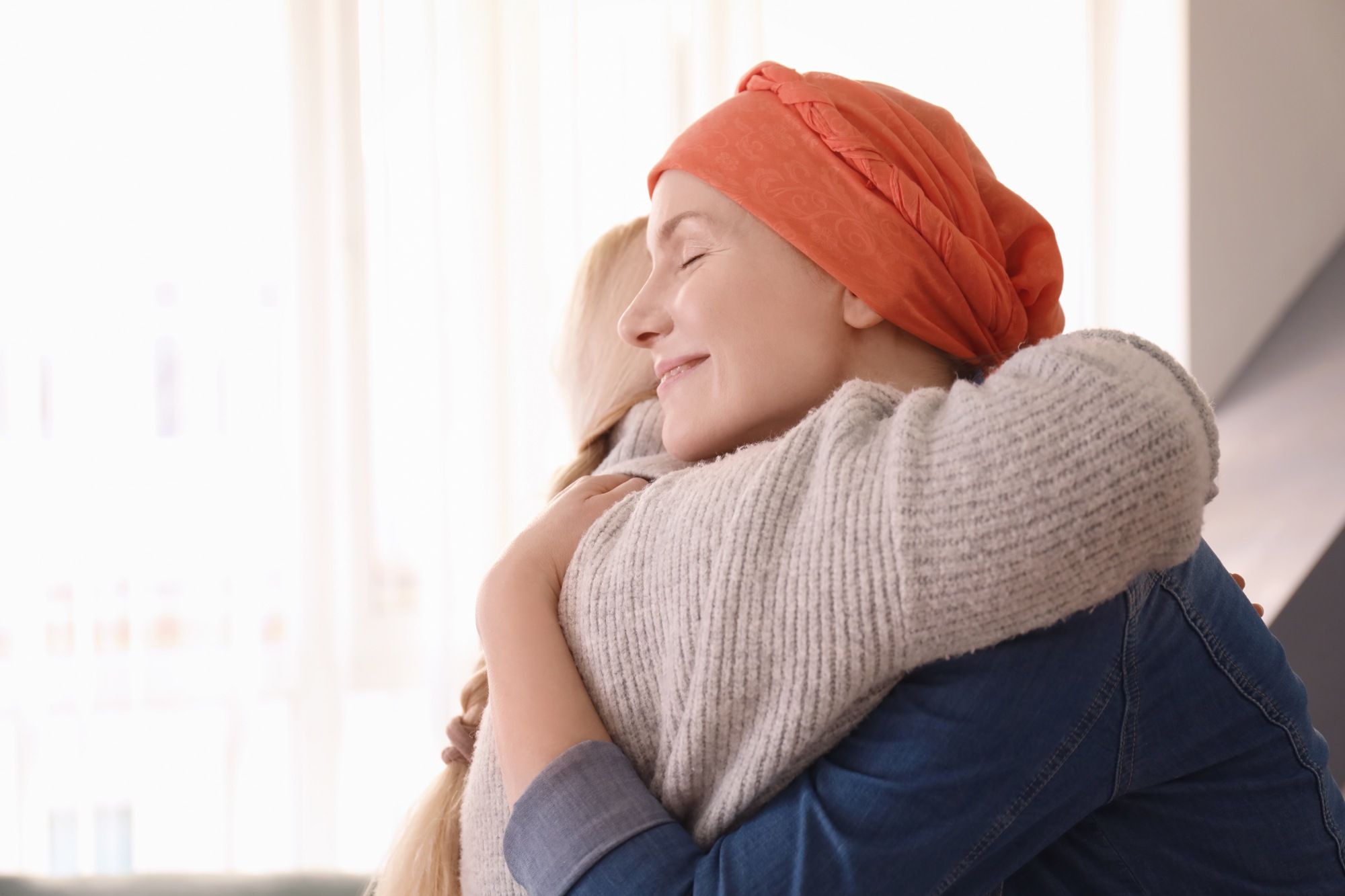 Daughter hugs mom with cancer
