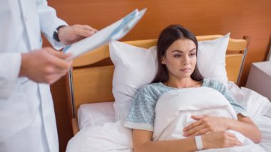 Doctor visits female patient in hospital