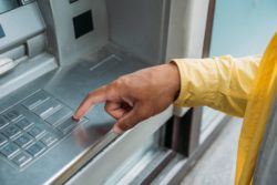 hand using ATM machine