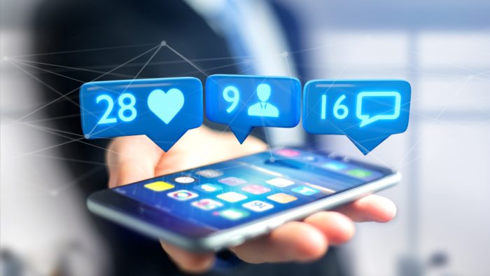 smartphone with Facebook app likes and comments