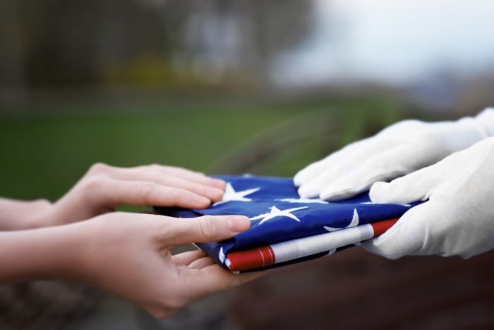 folded flag presented to veteran's family at death