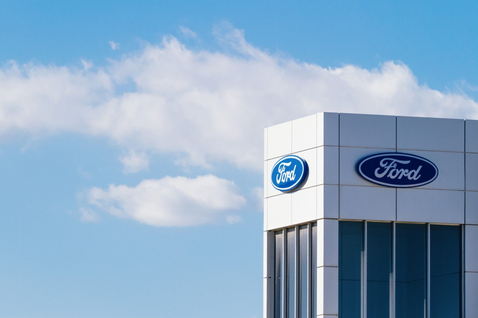 Ford logo near top of tall building - Freeplay Music