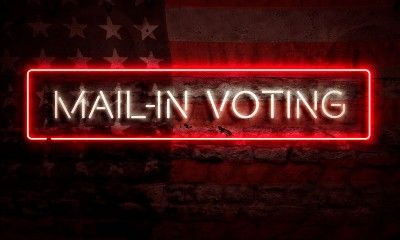 Red-and-white neon "mail-in voting" sign over old American flag
