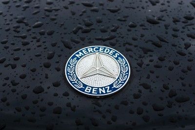 Mercedes-Benz logo on wet car hood - mercedes bluetec