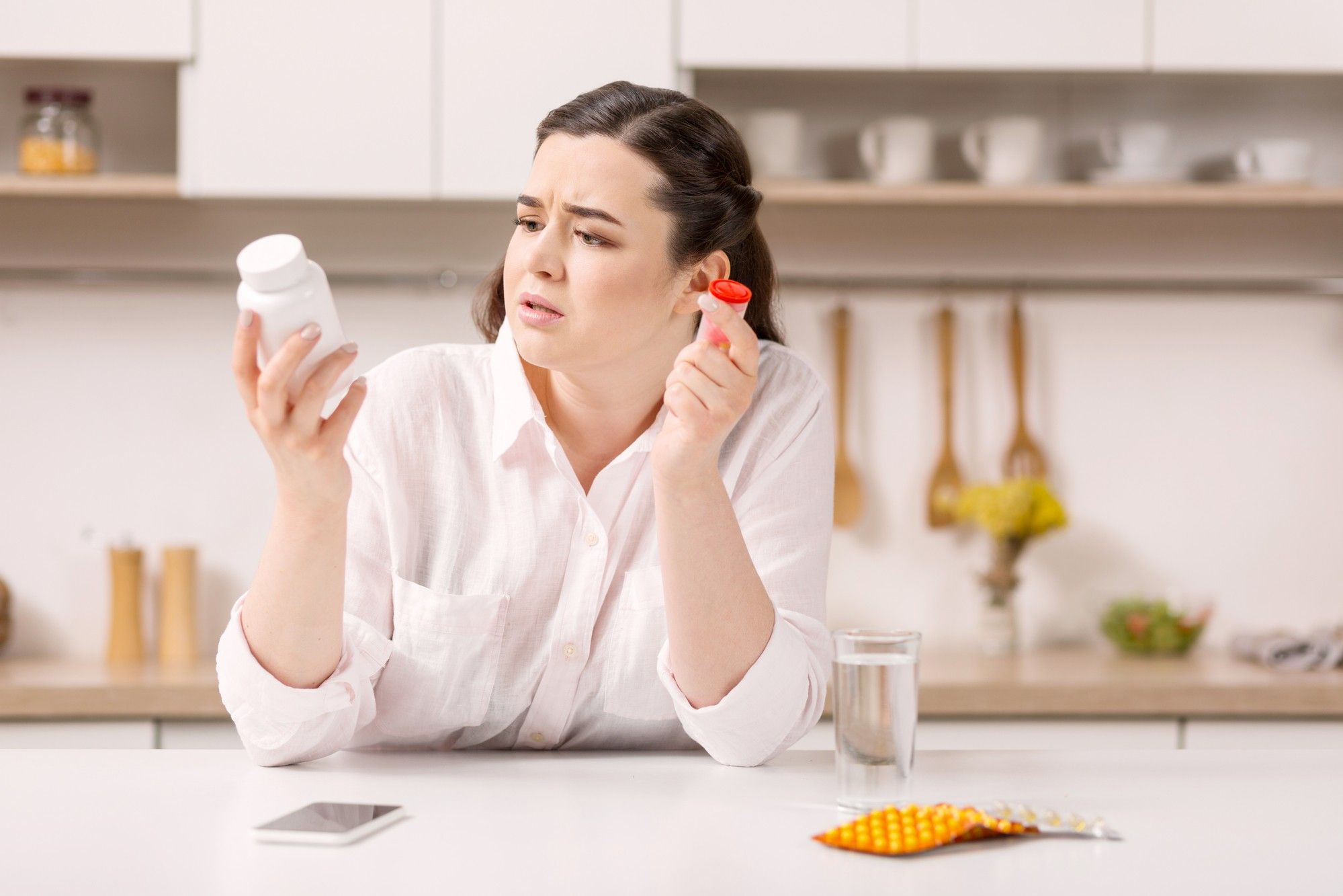 woman looking at Belviq weight loss medication bottle