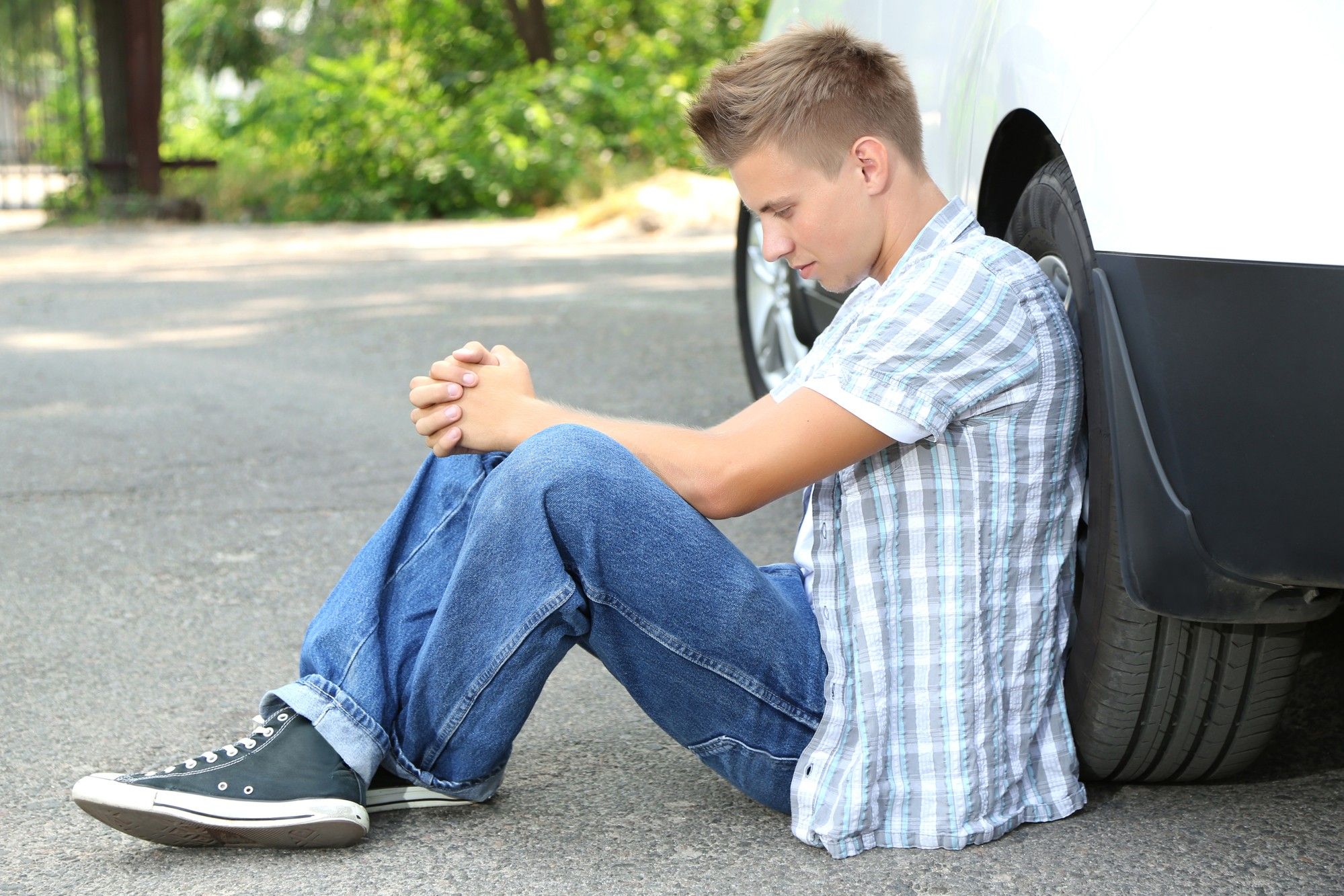 Young man waiting for a tow truck