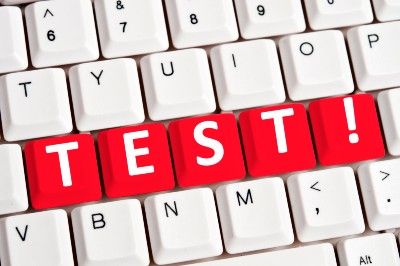 The word "Test!" is spelled out in red keys on a white keyboard - College Board AP Exams