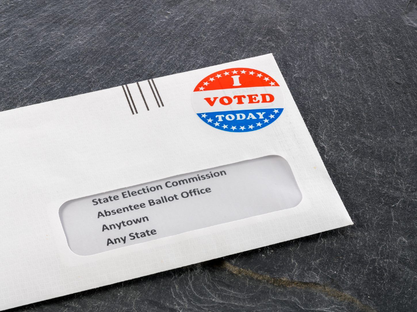 Envelope addressed to state election commission with an "I voted today" sticker in place of a stamp - voting by mail